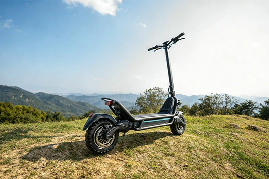 Off-road capable commuter electric scooter displayed on scenic mountain overlook with clear blue sky